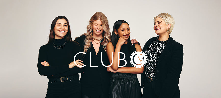Four women standing together with 'CLUB M' logo overlayed on a plain background